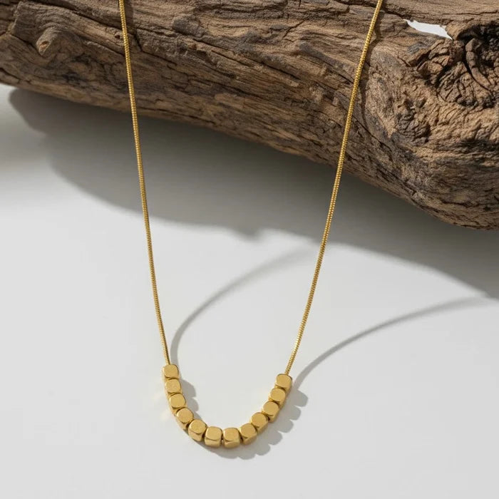 Fine gold-toned necklace with cube beads